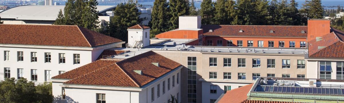 Financial Services Arial view of campus, with several buildings, stadium and bay in background