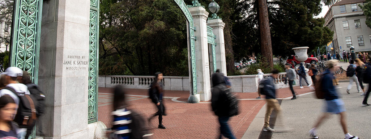 Blurred movement of students through Sather Gate