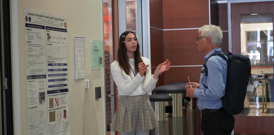 Girl explaining scientific poster