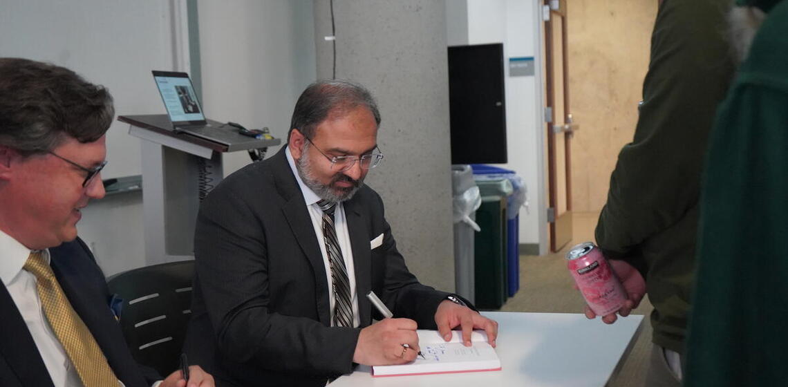 Irfan Siddiqi and Andrew Jordan signing their book