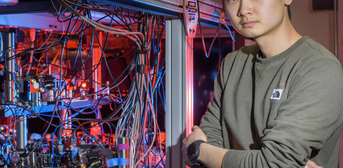 Man standing next to scientific equipment