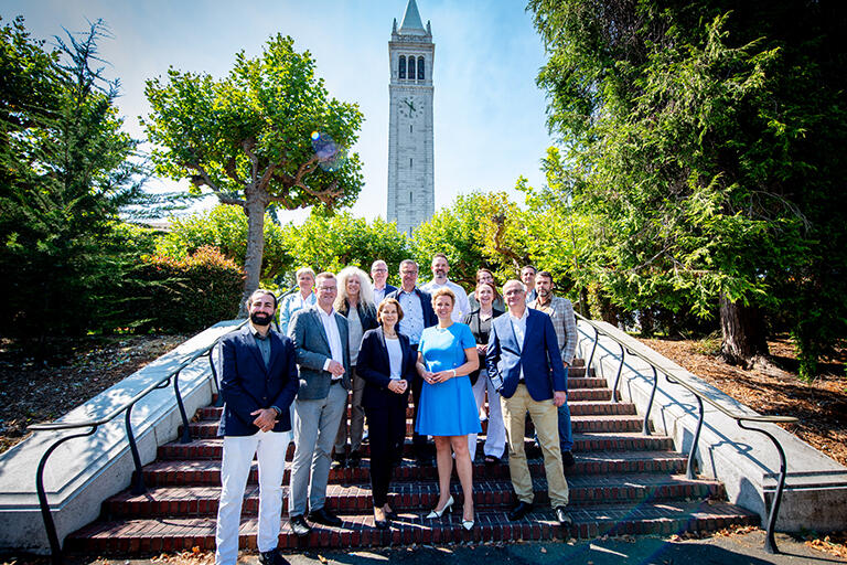 NRW delegates with Quantum Nanoelectronics Lab scientist Dr. Kasra Nowrouzi on the steps in front of the campanile