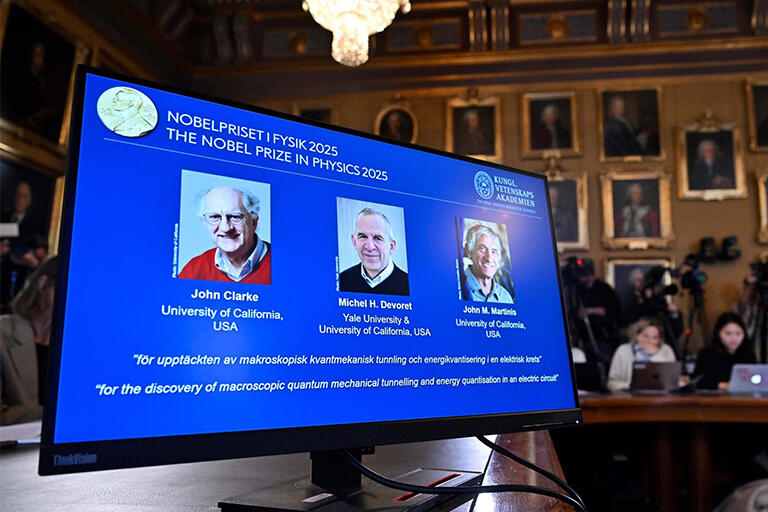 John Clarke, Michel H Devoret and John M. Martinis pictured on screen
